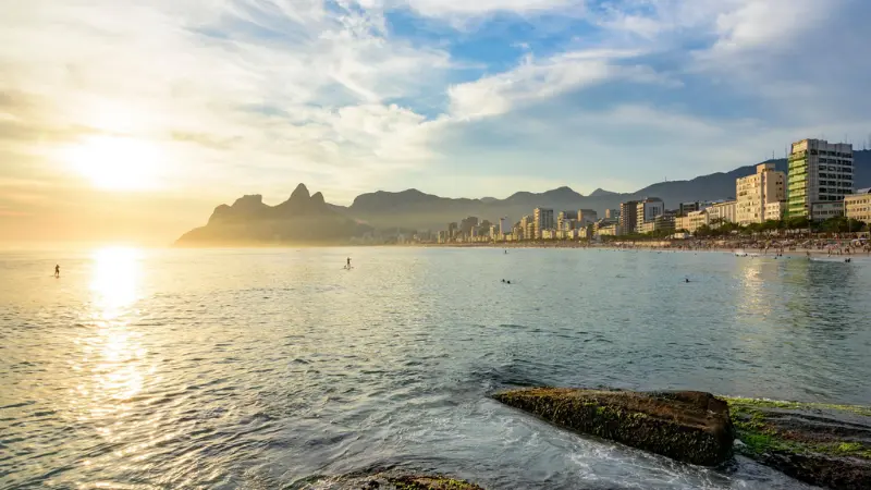  wide view of Ipanema Beach with city buildings in Rio