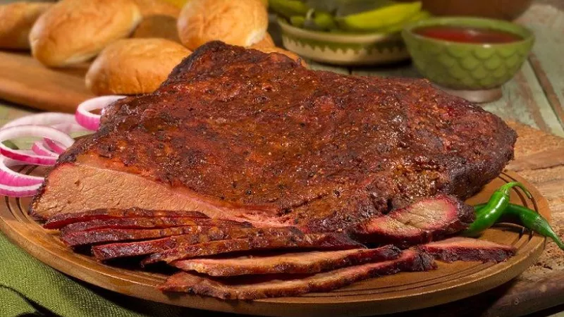 Texas BBQ brisket platter with sliced smoked meat, buns, and pickles at Tender Smokehouse Celina