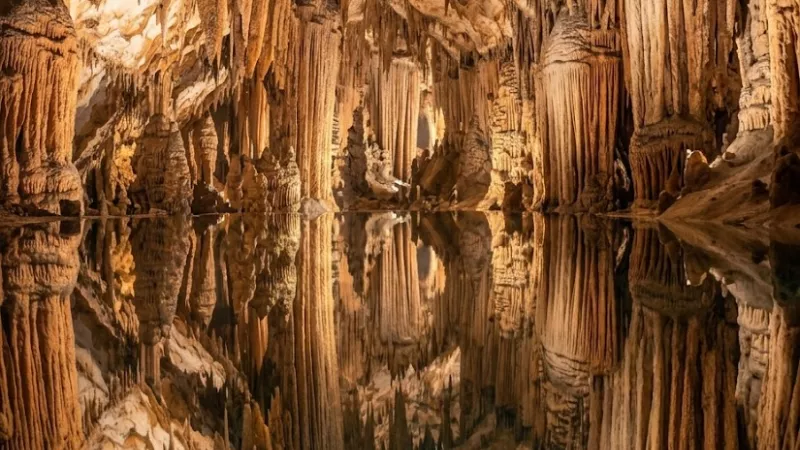 Mirror-still underground pool reflecting stalactites at Dream Lake inside Luray Caverns Virginia