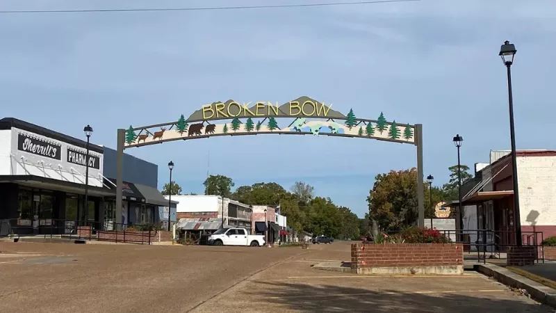 Broken Bow Oklahoma downtown street with welcome arch sign and small-town shops