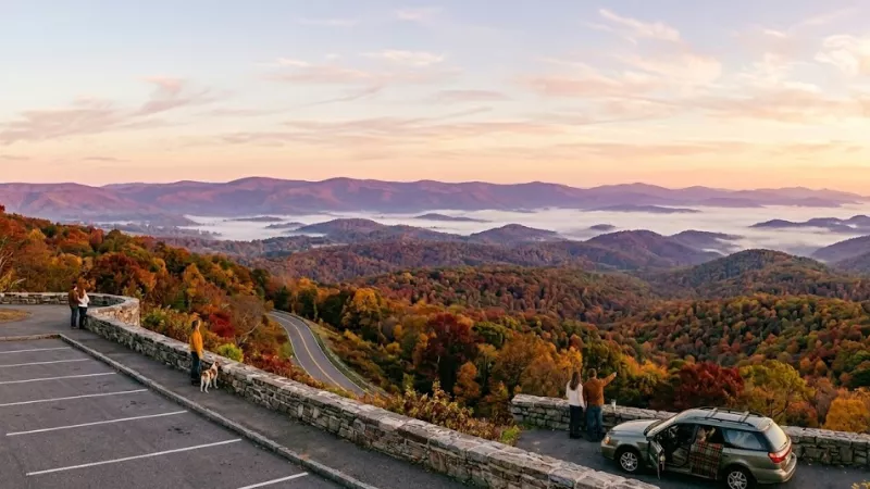 Country road near Luray VA lined with peak fall foliage and a split-rail fence in late October showing valley color away from Skyline Drive crowds