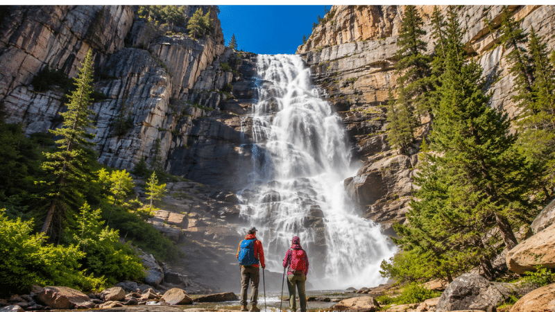  Two hikers at the base of Tokopah Falls in Sequoia National Park
