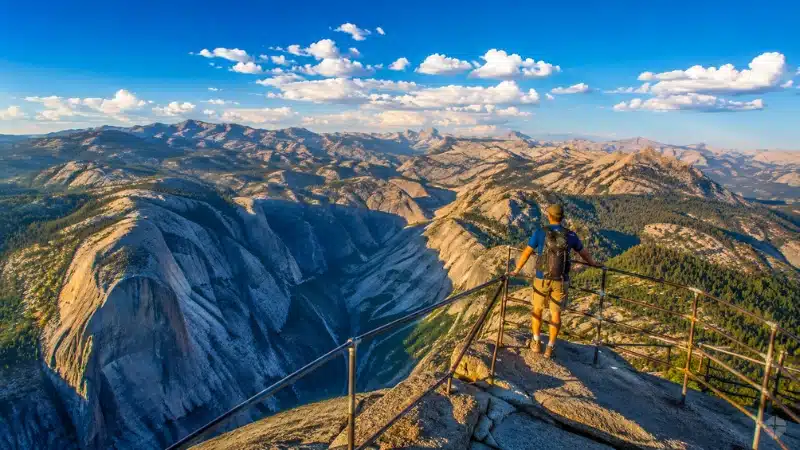  Hiker looking out from Moro Rock summit over Sierra Nevada mountains in Sequoia National Park