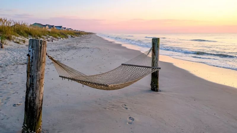Weekend in Pawleys Island: A Real 2-Day Plan 2 Quiet Pawleys Island beach at sunrise with a rope hammock near the dunes