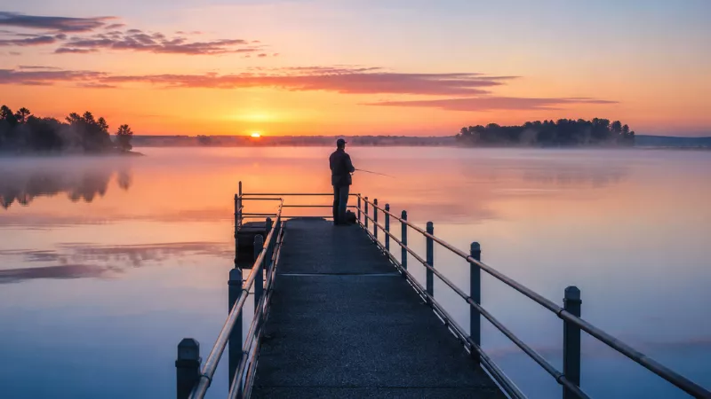 The Best Time to Visit Celina, Ohio 3 angler fishing at sunrise on Grand Lake St. Marys pier in Celina Ohio in spring