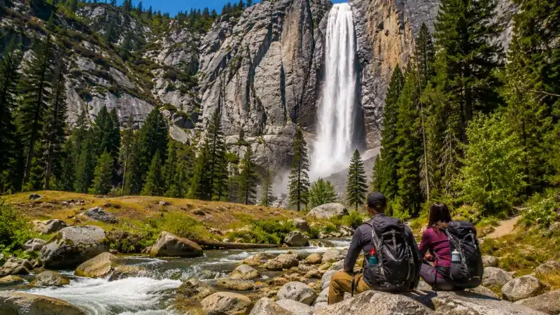 Tokopah Falls cascading over granite with hikers resting on boulders below on a two day Sequoia itinerary
