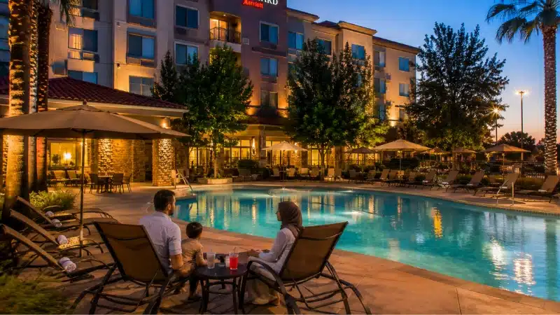 Hotel pool at dusk in Visalia, a budget-friendly base with full amenities near Sequoia National Park