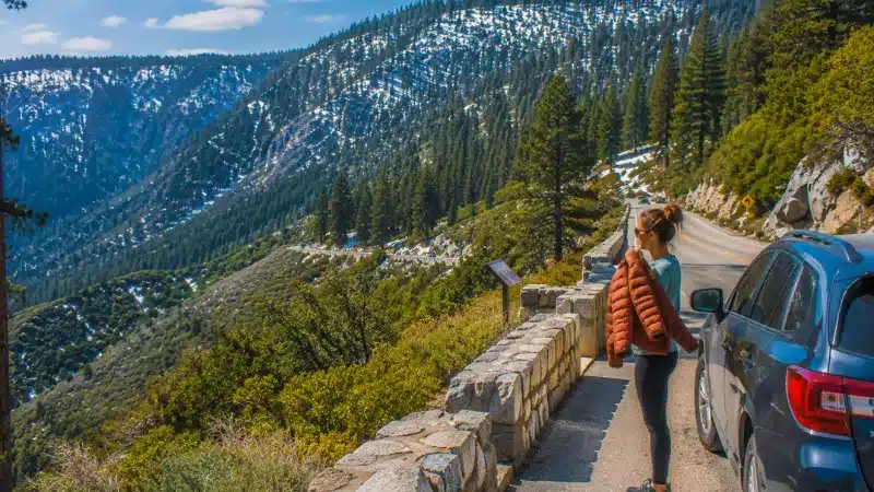 Traveler adding a layer at a pullout where the warm foothills meet the cooler groves